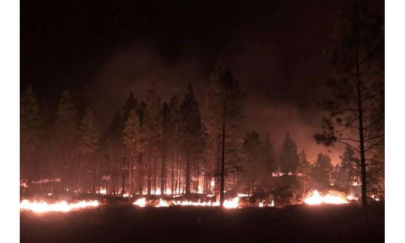 California fire prompts evacuations; Oregon blaze balloons