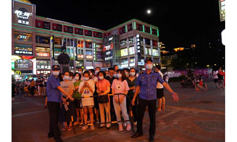 Chinese city locks down neighborhood after virus upsurge
