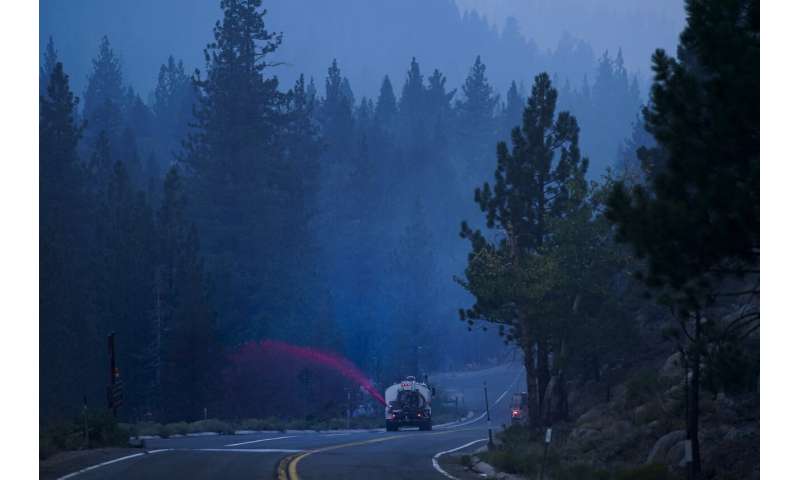 Huge wildfire near Lake Tahoe slows as weather improves