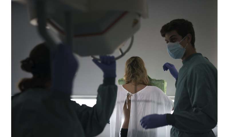 New virus surge sends younger patients to Spain's hospitals
