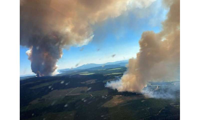 Plumes of smoke rise from the Long Loch wildfire and the Derrickson Lake wildfire in British Columbia on June 30, 2021