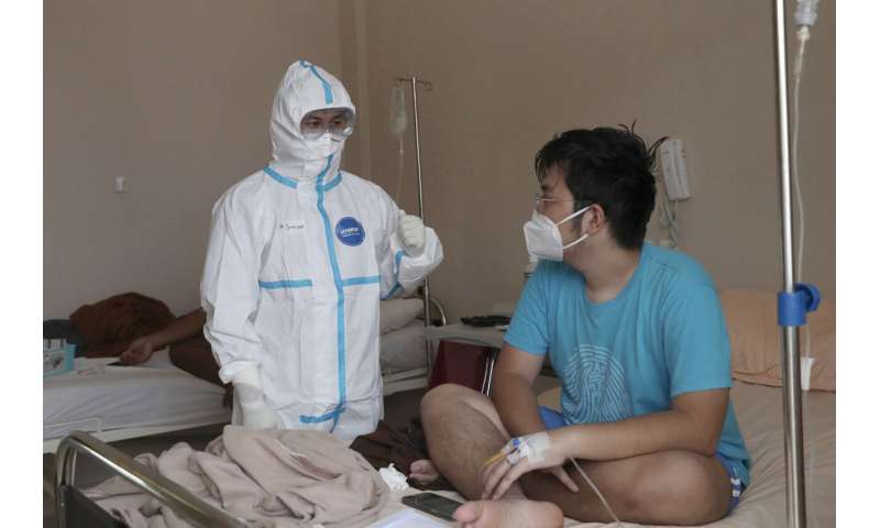 Rapid virus spread through Indonesia taxes health workers
