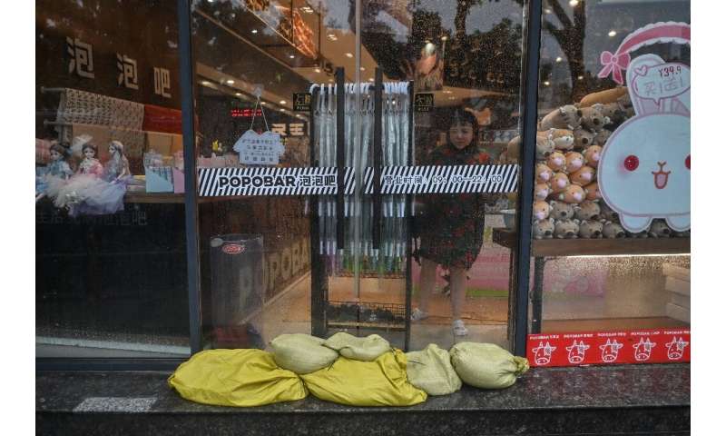 Residents of Ningbo have been preparing for the coming typhoon, which is already bringing strong gusts and rain