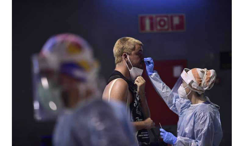 Spain restricts some nightlife as virus surges among young