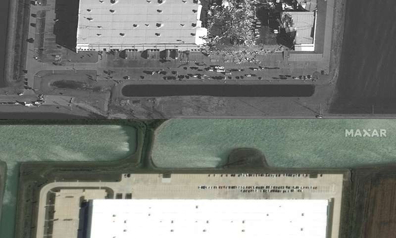 This handout satellite image released by Maxar Technologies shows (top) an overview of an Amazon warehouse after tornadoes hit t