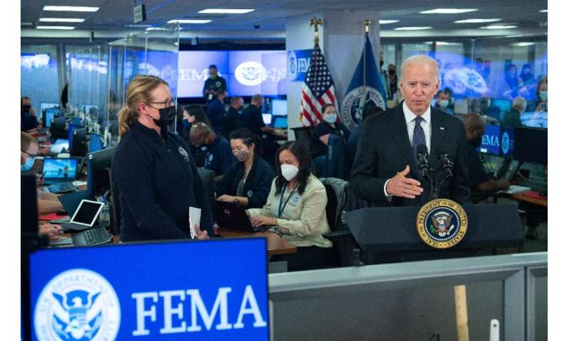 US President Joe Biden speaks about Hurricane Ida alongside FEMA Administrator Deanne Criswell (L) during a visit to FEMA Headqu