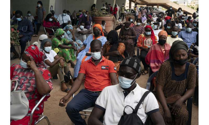 West African health officials race to vaccinate amid spikes