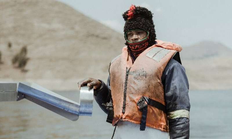 Dlodlo, a 26-year-old fish-farm worker, at the end of a day's harvesting