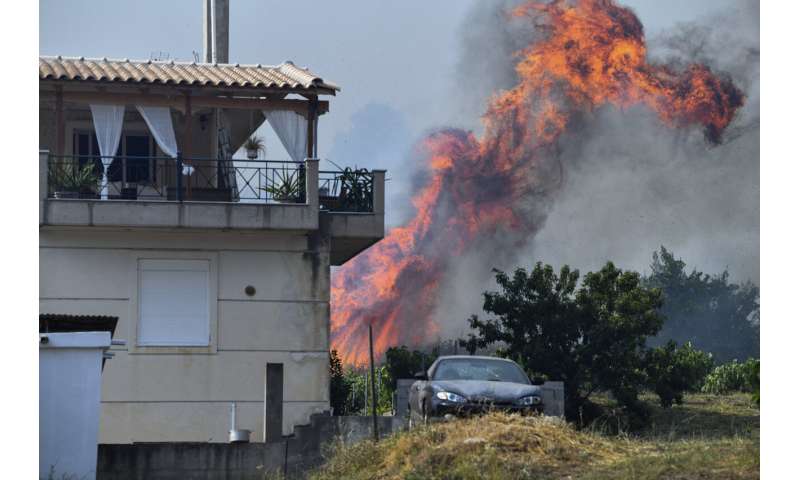 Fire damages homes in southern Greece; more blazes active