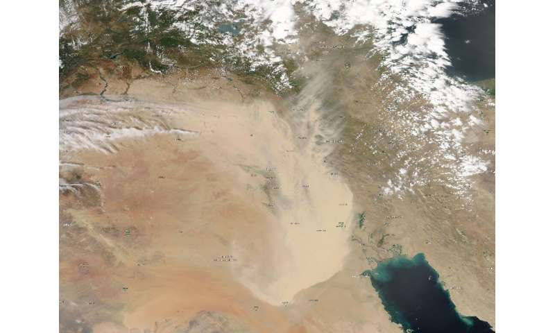 In this handout satellite image courtesy of NASA Earth Observatory taken on May 16, 2022, a dust storm engulfs parts of Iraq and