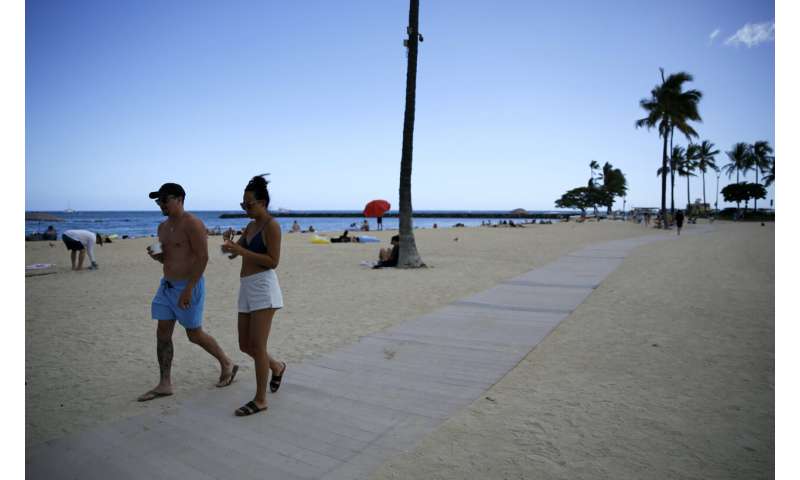 Pandemic-weary Americans plan for summer despite COVID surge