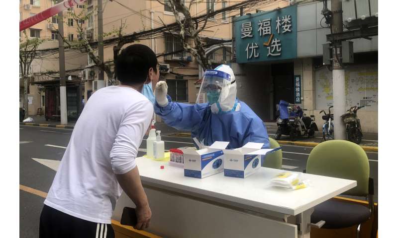 Shanghai discharges thousands of patients, boosts supplies