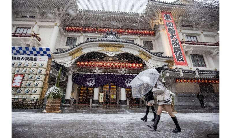 Some people in the Japanese capital took the time to soak up the unusual snowfall