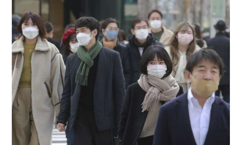 Tokyo reports record virus cases as Japan tightens measures