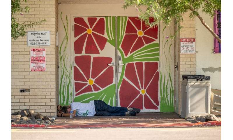 A homless person lies in the shade during the heat wave in Phoenix, Arizona, in July 2023