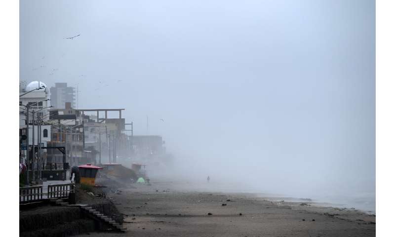 A man walks on the beach as Tropical Storm Hilary approaches the US-Mexico border in Playas de Tijuana, Mexico on August 20, 202