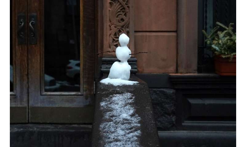 A small snowman sits on a stoop on New York's West Side on February 28, 2023