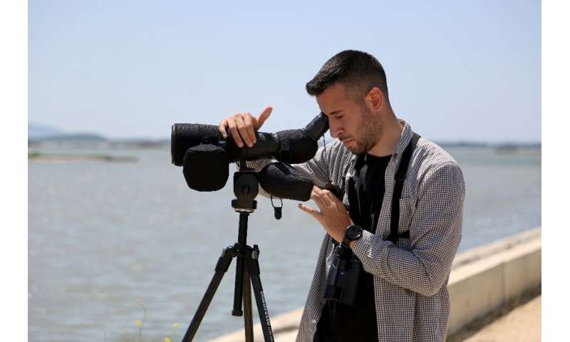 'Goes against nature': environmentalist Zydjon Vorpsi observes birds at the Narta lagoon in southern Albania