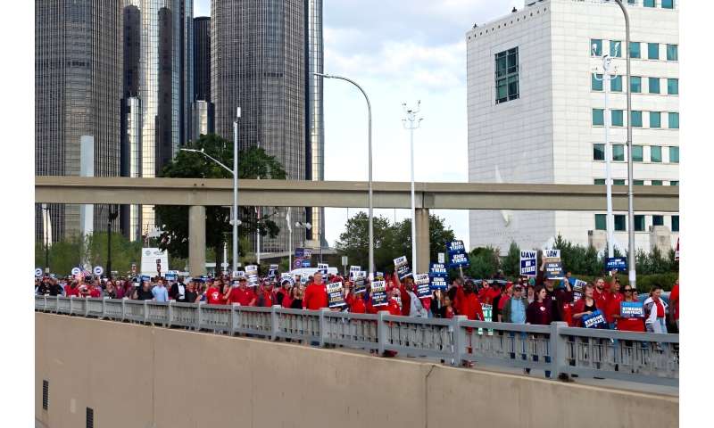 Members of the United Auto Workers (UAW) union march through the streets of downtown Detroit following a rally on the first day of the UAW strike in Detroit, Michigan, on September 15, 2023