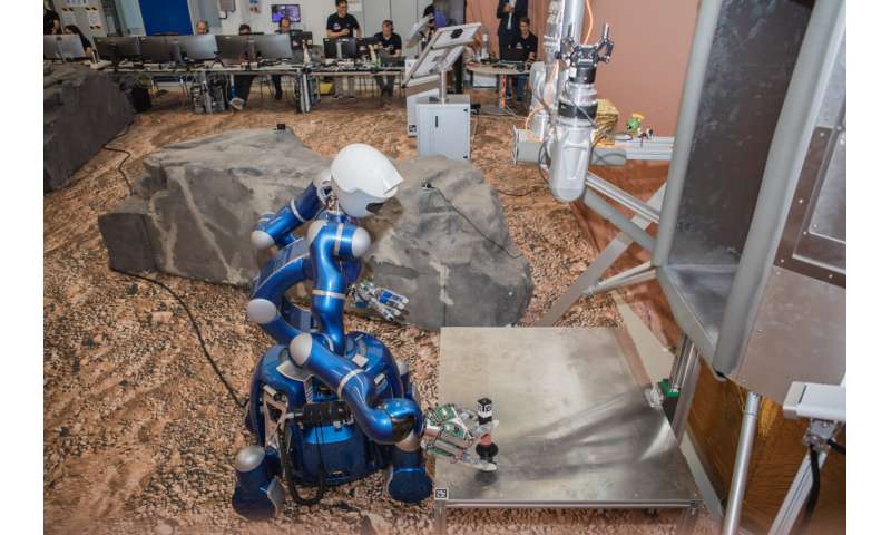 Orbiting astronaut oversees robot team on Earth