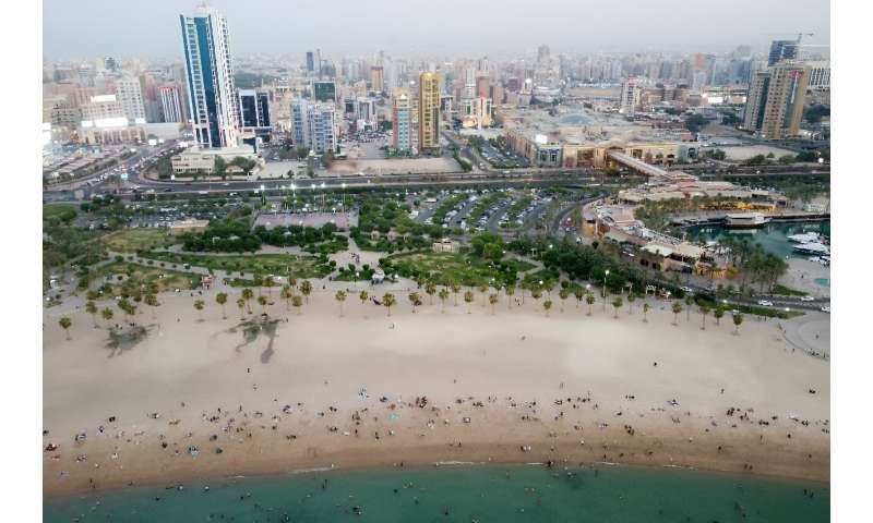 People flock to the beach to escape the heat in Kuwait City on July 7, 2023