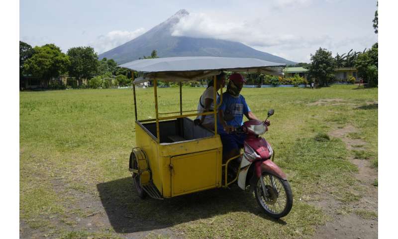 Philippine villagers flee ashfall, sight of red-hot lava from erupting Mayon Volcano