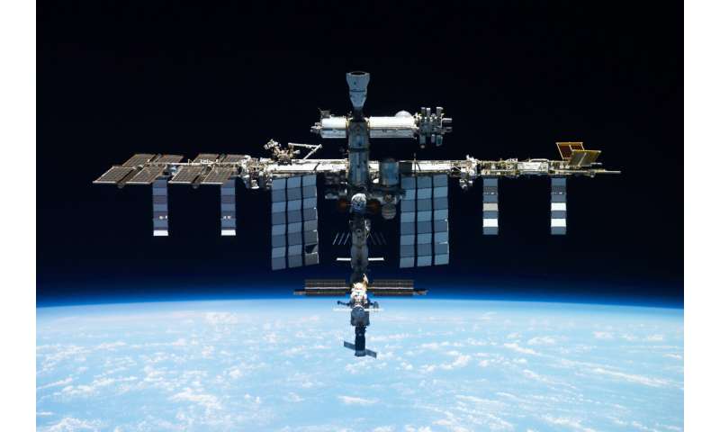 Russia reports coolant leak in backup line at space station and says crew not in danger