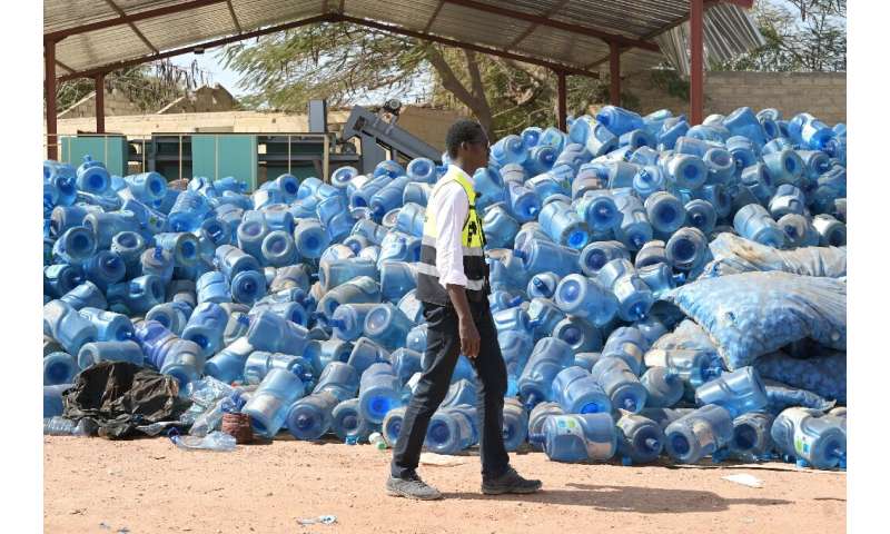 Senegalese rubbish collector Abdou Bakhy Mbacke has a mountain of water canisters awaiting recycling