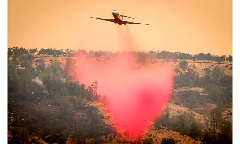 An air tanker drops fire retardant on a ridge as California's Park fire burns on July 27, 2024
