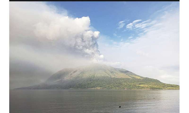 Indonesians leave homes near erupting volcano and airport closes due to ash danger