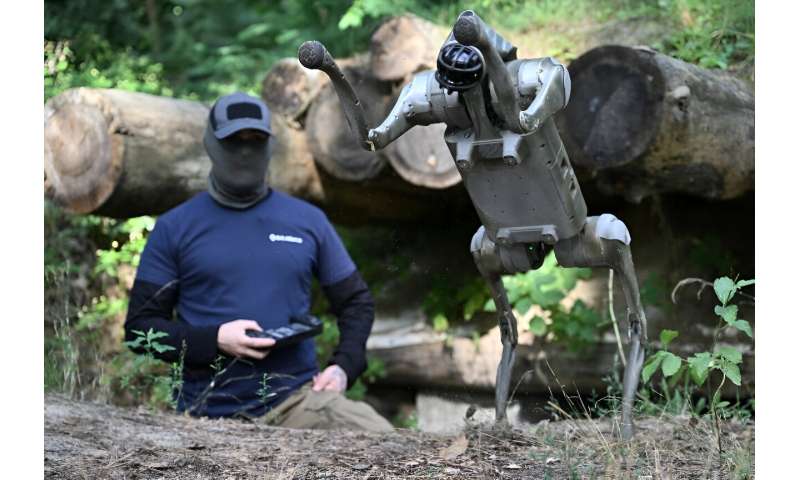 Operator 'Yuri' demonstrates the capabilities of a robot dog from his trench