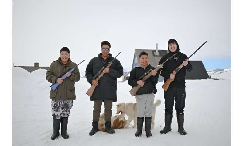 Peter Hammeken (2nd left) and his sons. Hunting is not just a way of life for the Inuit of Ittoqqortoormiit, it is needed for survival