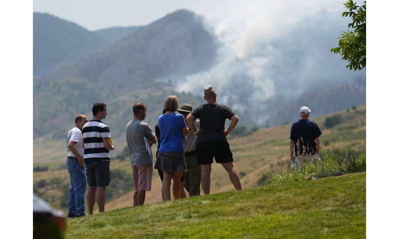 Wildfires encroach on homes near Denver as heat hinders fight