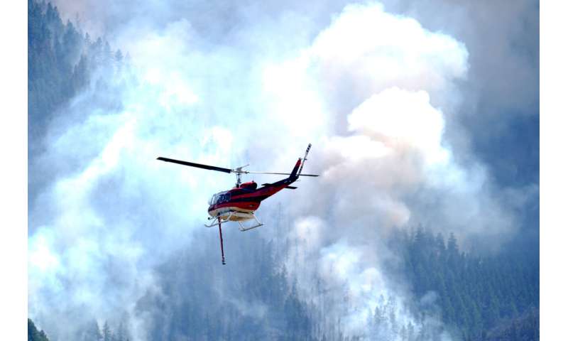 Wildfires encroach on homes near Denver as heat hinders fight