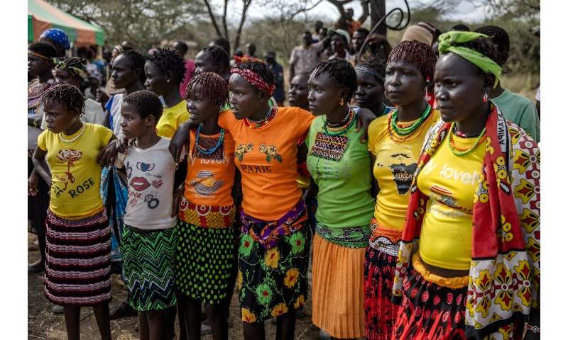 Women wear traditional attire as the community celebrates the arrival of the giraffes