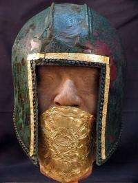 A handout photo shows a warrior's bronze helmet with gold mouth protector dated to the 6th century BC