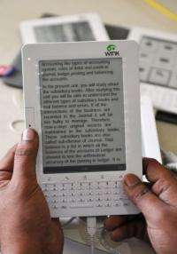 A man works on his Kindle-style tablet called Wink
