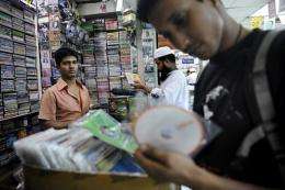 A shopper looks at counterfeit computer programmes in Dhaka