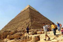A tourist walks in front the Great Pyramid