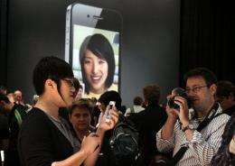 Members of the media inspect the new iPhone 4