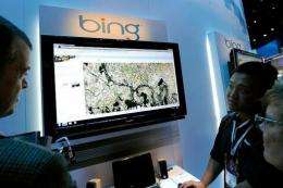 Microsoft's Roger Wong (2nd R) demonstrates maps using Bing