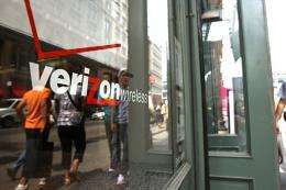 People walk by a Verizon store in New York