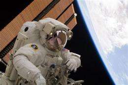 Astronauts remove troublesome cargo container (AP)