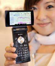 A model displays a "Stock mobile phone" produced by Sharp
