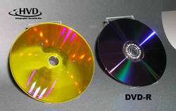 Holographic Versatile Disc™ (HVD™) on which digital movies were recorded (left). The disc diameter of 12 centimeters is equivale