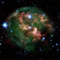 This false-color image from NASA's Spitzer Space Telescope shows a dying star (center) surrounded by a cloud of glowing gas and