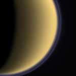 Encircled in purple stratospheric haze, Titan appears as a softly glowing sphere in this colorized image taken one day after Cas