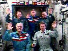 Space station residents wave to dignitaries in Russia during a live event last Thursday. Credit: NASA TV