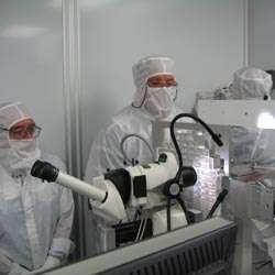 Scientists inspect backup aerogel collector grid.