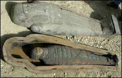 Open coffin and a mummy at an excavation south of Cairo
